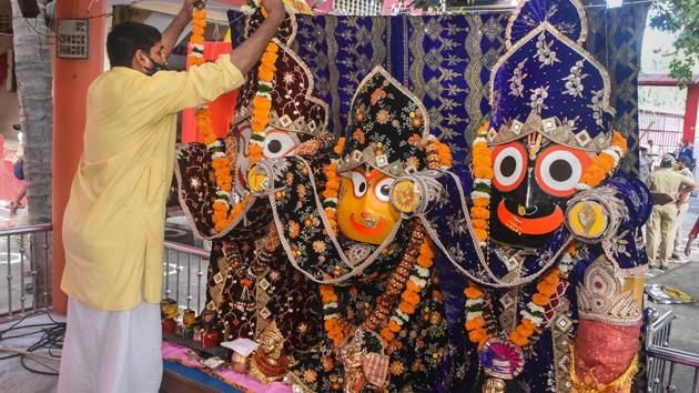 Surat: A priest garlands the idols of Lord Jagannath, Balabhadra and Subhadra on the occasion of the Rath Yatra festival at Jagannath Temple in Surat, Tuesday, June 23, 2020. (PTI) 