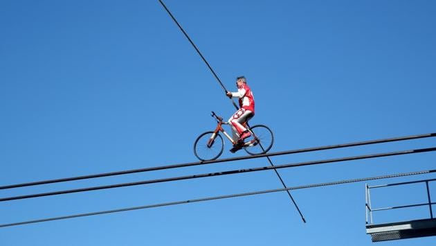 A closer look at Swiss acrobat Freddy Nock balances on a bicycle on the cable of the Glacier 3000 cable car during the Airshow in Les Diablerets on June 23.The stunts were apparently also to honour artists around the globe who’ve been affected by the pandemic. (Denis Balibouse / REUTERS)
