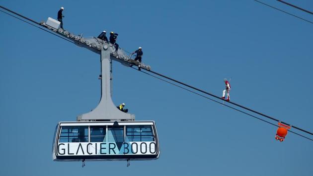 Freddy Nock walks blindfolded on the cable of the Glacier 3000 cable car during the Airshow in Les Diablerets on June 23. Public events with more than 1,000 people are set to return from September, while this Airshow marked the opening of full activities this weekend in Les Diablerets. (Denis Balibouse / REUTERS)