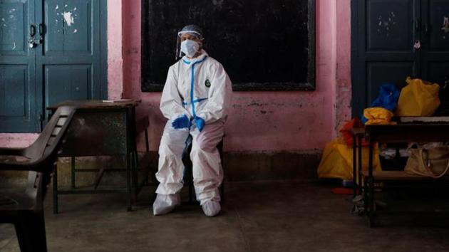 File photo: A medical worker sits inside a classroom as she takes a break at a school which was turned into a centre to conduct tests for the coronavirus disease in New Delhi.(REUTERS) File photo: A medical worker sits inside a classroom as she takes a break at a school which was turned into a centre to conduct tests for the coronavirus disease in New Delhi.(REUTERS)