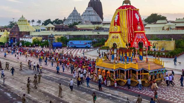 Priests and policemen pull the three chariots of Lord Jagannath, Balarama, and Subhadra from the construction site (Ratha Khala) to Jagannatha Temple for the annual Rath Yatra.(PTI Photo)