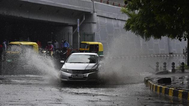 A car wades through a waterlogged road in Moti Bagh, New Delhi. LPA is the average of rainfall received in the area over a 50-year period. In this case between 1951 and 2000. (Sanjeev Verma / HT Photo)
