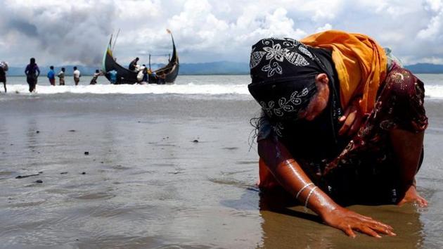 In this file photo, an exhausted Rohingya refugee woman touches the shore after crossing the Bangladesh-Myanmar border by boat through the Bay of Bengal in Shah Porir Dwip, Bangladesh (REUTERS/For Representational Purposes Only) In this file photo, an exhausted Rohingya refugee woman touches the shore after crossing the Bangladesh-Myanmar border by boat through the Bay of Bengal in Shah Porir Dwip, Bangladesh (REUTERS/For Representational Purposes Only)