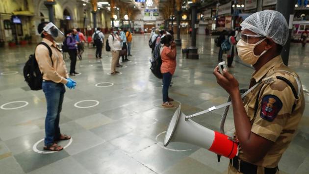 A railway police personnel makes an announcement as passengers wait to board a train at a railway station in Mumbai on June 22. When the lockdown kicked off, movement at transit hubs such as trains and metro stations dropped 73% from the baseline. In the four weeks since, it recovered slightly and continues to remain around 60% below baseline. (Francis Mascarenhas / REUTERS) A railway police personnel makes an announcement as passengers wait to board a train at a railway station in Mumbai on June 22. When the lockdown kicked off, movement at transit hubs such as trains and metro stations dropped 73% from the baseline. In the four weeks since, it recovered slightly and continues to remain around 60% below baseline. (Francis Mascarenhas / REUTERS)