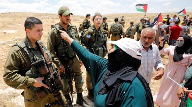 Palestinians argue with Israeli soldiers during a protest against Israel's plan to annex parts of the occupied West Bank, in Susya village south of Heron. (REUTERS) Palestinians argue with Israeli soldiers during a protest against Israel's plan to annex parts of the occupied West Bank, in Susya village south of Heron. (REUTERS)