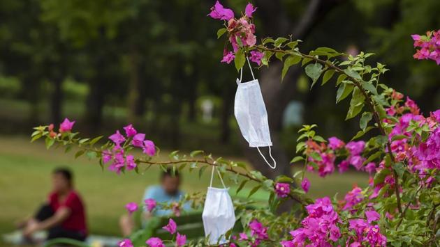 Face masks hang from a plant as people exercise at Nehru Park in New Delhi on June 21. Parks were one of the fields that showed the least recovery. On May 25, data shows that 54% fewer people logged in and around parks in India. This went on to drop to as much as -68% by the end of March. And though it since recovered slightly, movement remained -56% on June 14 – the latest day for which data is available. (Shahbaz Khan / PTI) Face masks hang from a plant as people exercise at Nehru Park in New Delhi on June 21. Parks were one of the fields that showed the least recovery. On May 25, data shows that 54% fewer people logged in and around parks in India. This went on to drop to as much as -68% by the end of March. And though it since recovered slightly, movement remained -56% on June 14 – the latest day for which data is available. (Shahbaz Khan / PTI)