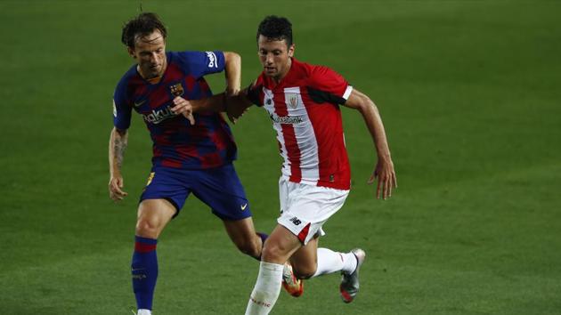 Barcelona's Ivan Rakitic, left, vies for the ball with Athletic Bilbao's Mikel San Jose during the Spanish La Liga soccer match between FC Barcelona and Athletic Bilbao at the Camp Nou stadium in Barcelona, Spain, Tuesday, June 23, 2020.(AP) Barcelona's Ivan Rakitic, left, vies for the ball with Athletic Bilbao's Mikel San Jose during the Spanish La Liga soccer match between FC Barcelona and Athletic Bilbao at the Camp Nou stadium in Barcelona, Spain, Tuesday, June 23, 2020.(AP)
