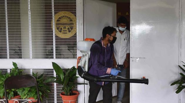 Workers sanitising the administrative block at Panjab University, Chandigarh, on Wednesday. (Keshav Singh/HT) Workers sanitising the administrative block at Panjab University, Chandigarh, on Wednesday. (Keshav Singh/HT)