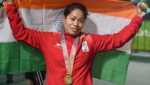 Indian weightlifter Sanjita Chanu poses with the tricolour for a photo after winning gold in the women's 53kg Weightlifting event during the Commonwealth Games 2018 in Gold Coast.(PTI)