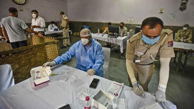 Medical professionals and police personnel work together during sample collection for COVID-19 testing in Pilanji Village, New Delhi on June 23. According to the revised Standard Operating Procedure (SOP) on the COVID-19 response plan, house-to-house screening will be conducted in Delhi by July 6. (Biplov Bhuyan / HT Photo) Medical professionals and police personnel work together during sample collection for COVID-19 testing in Pilanji Village, New Delhi on June 23. According to the revised Standard Operating Procedure (SOP) on the COVID-19 response plan, house-to-house screening will be conducted in Delhi by July 6. (Biplov Bhuyan / HT Photo)