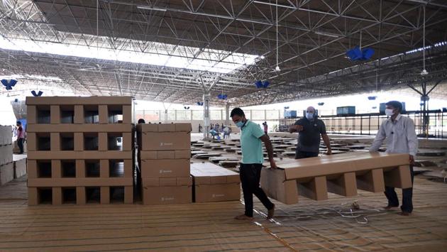 Cardboard beds being assembled and placed in Radha Soami Satsang Beas Center for COVID-19 patients in Chhatarpur, New Delhi on June 24. On June 25, Lt. Governor of Delhi Anil Baijal chaired a Delhi Disaster Management Authority meeting yesterday where he reversed an order that mandated all COVID-19 patients to visit state-run care facilities for clinical assessment. (Ajay Aggarwal / HT Photo) Cardboard beds being assembled and placed in Radha Soami Satsang Beas Center for COVID-19 patients in Chhatarpur, New Delhi on June 24. On June 25, Lt. Governor of Delhi Anil Baijal chaired a Delhi Disaster Management Authority meeting yesterday where he reversed an order that mandated all COVID-19 patients to visit state-run care facilities for clinical assessment. (Ajay Aggarwal / HT Photo)