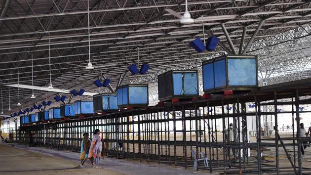 Large ceiling fans, with one for every three patients currently service the vast hall that makes the facility. Dozens of large air-conditioner units like those pictured here, have been installed with more on the way. The nursing area will be kept cooler in consideration for medical staff who spend long hours in layers of PPE gear. (Ajay Aggarwal /HT Photo) Large ceiling fans, with one for every three patients currently service the vast hall that makes the facility. Dozens of large air-conditioner units like those pictured here, have been installed with more on the way. The nursing area will be kept cooler in consideration for medical staff who spend long hours in layers of PPE gear. (Ajay Aggarwal /HT Photo)