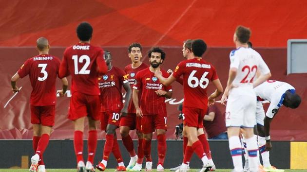 Soccer Football - Premier League - Liverpool v Crystal Palace - Anfield, Liverpool, Britain - June 24, 2020 Liverpool's Mohamed Salah celebrates scoring their second goal with teammates. (REUTERS) Soccer Football - Premier League - Liverpool v Crystal Palace - Anfield, Liverpool, Britain - June 24, 2020 Liverpool's Mohamed Salah celebrates scoring their second goal with teammates. (REUTERS)