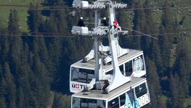 Swiss acrobat David Maillard performs with an elastic tape under a cable of the Glacier 3000 cable car during the Airshow, marking the reopening of the facilities after the coronavirus disease (COVID-19) lockdown in Les Diablerets, Switzerland, June 23, 2020. (REUTERS/Denis Balibouse)