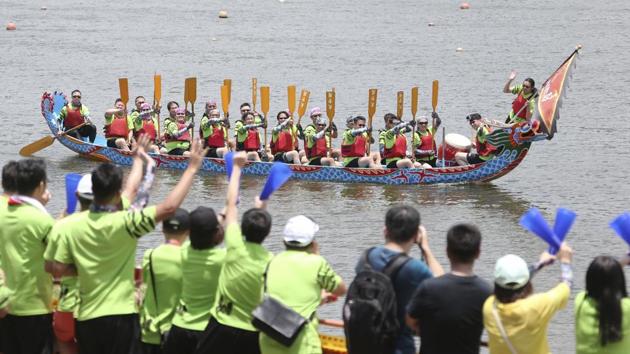 Dragon boat crew members cheer during the traditional Chinese dragon boat race in Taipei, Taiwan, Thursday, June 25, 2020. Dragon boat races are in remembrance of Chu Yuan, an ancient Chinese scholar-statesman, who drowned in 277 B.C. while denouncing government corruption. (AP)