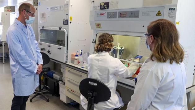 Britain's Prince William, left, wears a mask as he meets scientist Christina Dold, right, during a visit to the manufacturing laboratory where a vaccine against COVID-19 has been produced, at the Oxford Vaccine Group's facility at the Churchill Hospital in Oxford, England, Wednesday, June 24, 2020. (AP) Britain's Prince William, left, wears a mask as he meets scientist Christina Dold, right, during a visit to the manufacturing laboratory where a vaccine against COVID-19 has been produced, at the Oxford Vaccine Group's facility at the Churchill Hospital in Oxford, England, Wednesday, June 24, 2020. (AP)