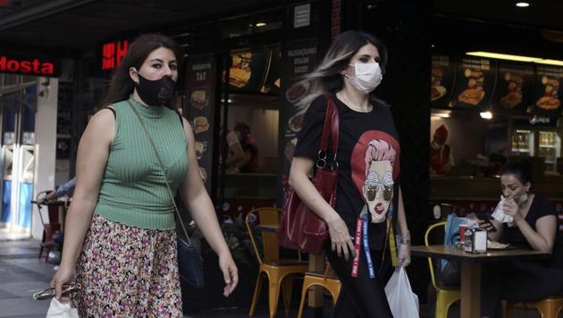 Women wearing face masks to protect against the spread of coronavirus, walk in the city centre, in Ankara, Turkey on Wednesday.(AP Photo)