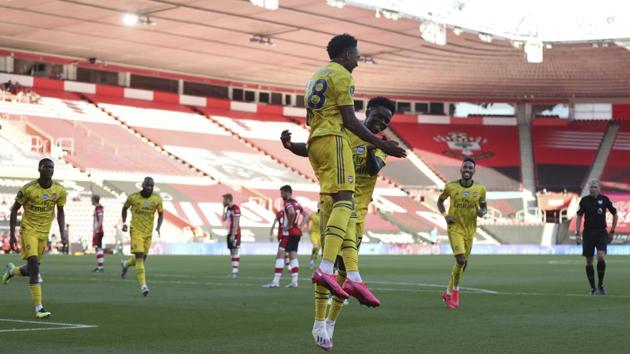Arsenal's Joe Willock, center, celebrates with his teammates after scoring his side's second goal during the English Premier League soccer match between Southampton and Arsenal at St Mary's Stadium, in Southampton, England, Thursday, June 25, 2020. (AP) Arsenal's Joe Willock, center, celebrates with his teammates after scoring his side's second goal during the English Premier League soccer match between Southampton and Arsenal at St Mary's Stadium, in Southampton, England, Thursday, June 25, 2020. (AP)