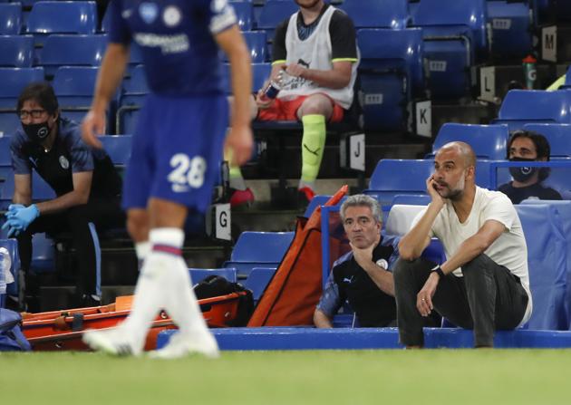 Manchester City's head coach Pep Guardiola watches play during the English Premier League soccer match between Chelsea and Manchester City at Stamford Bridge, in London, England, Thursday, June 25, 2020. (AP) Manchester City's head coach Pep Guardiola watches play during the English Premier League soccer match between Chelsea and Manchester City at Stamford Bridge, in London, England, Thursday, June 25, 2020. (AP)