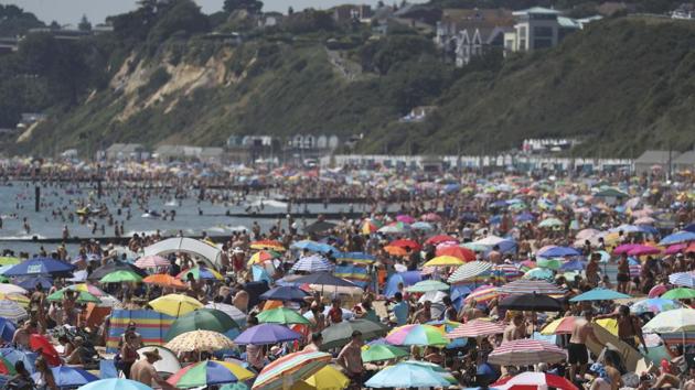 Crowds gather on the beach in Bournemouth as the UK experience a heat wave, in Bournemouth. (PTI) Crowds gather on the beach in Bournemouth as the UK experience a heat wave, in Bournemouth. (PTI)