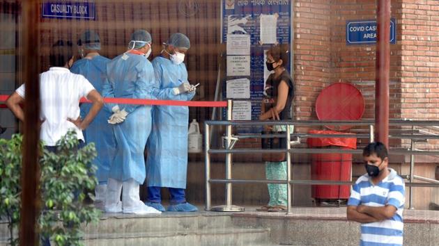 Medical professionals attend to a visitors outside the Covid-19 ward at LNJP hospital on June 25. LNJP has since also helped fill a gap in the treatment of Covid-19 patents by attending to their co-mobidites and other complications such as the need for dialysis and also helping in deliveries of Covid-19 positive women. (Sonu Mehta / HT Photo) Medical professionals attend to a visitors outside the Covid-19 ward at LNJP hospital on June 25. LNJP has since also helped fill a gap in the treatment of Covid-19 patents by attending to their co-mobidites and other complications such as the need for dialysis and also helping in deliveries of Covid-19 positive women. (Sonu Mehta / HT Photo)