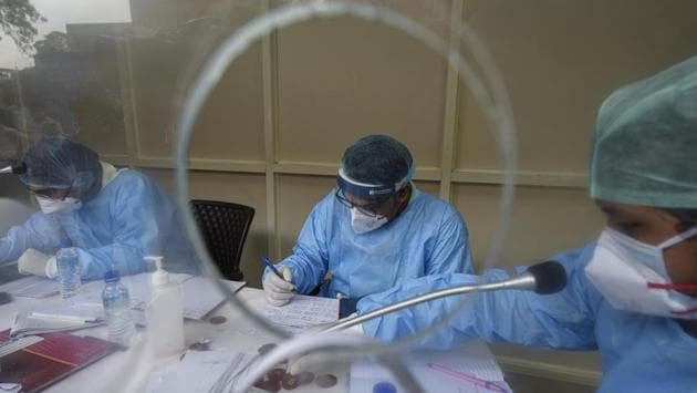 Medical workers in PPE suits on duty at the COVID-19 helpdesk, at Lok Nayak Jai Prakash (LNJP) Hospital in New Delhi on June 25. LNJP has been at the front of Delhi’s Covid-19 response ever since the city reported its first case of the disease on March 6. The hospital had at the time immediately set aside 11 isolation rooms for Covid-19 patients. (Biplov Bhuyan / HT Photo) Medical workers in PPE suits on duty at the COVID-19 helpdesk, at Lok Nayak Jai Prakash (LNJP) Hospital in New Delhi on June 25. LNJP has been at the front of Delhi’s Covid-19 response ever since the city reported its first case of the disease on March 6. The hospital had at the time immediately set aside 11 isolation rooms for Covid-19 patients. (Biplov Bhuyan / HT Photo)