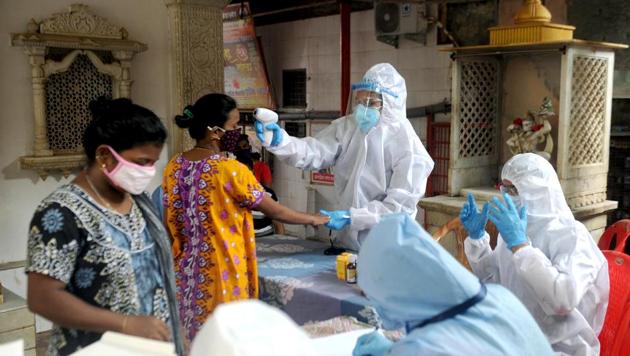 Health care staff check the temperature and pulse rate of the residents at a housing society in Mumbai’s Malad on Thursday. (ANI file photo) Health care staff check the temperature and pulse rate of the residents at a housing society in Mumbai’s Malad on Thursday. (ANI file photo)