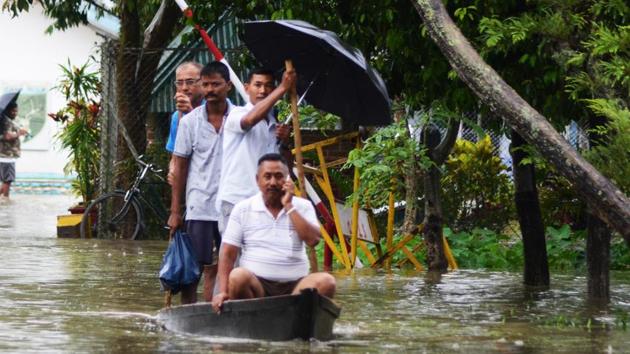 People move to safer place in a boat after floodwater enters the town in Assam’s Dibrugarh on Thursday(ANI Photo)