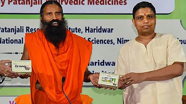 Baba Ramdev with Acharya Balkrishna launched an Ayurvedic medicine kit that they claimed can treat coronavirus patients within seven days on June 23, 2020.(@PypAyurved/Twitter Photo)