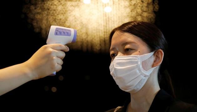 A woman has her body temperature checked by a hotel worker at the reception desk area of Mitsui Garden Hotel Nihonbashi Premier during the spread of the coronavirus disease (COVID-19) in Tokyo, Japan June 26, 2020. (Representational) (REUTERS) A woman has her body temperature checked by a hotel worker at the reception desk area of Mitsui Garden Hotel Nihonbashi Premier during the spread of the coronavirus disease (COVID-19) in Tokyo, Japan June 26, 2020. (Representational) (REUTERS)