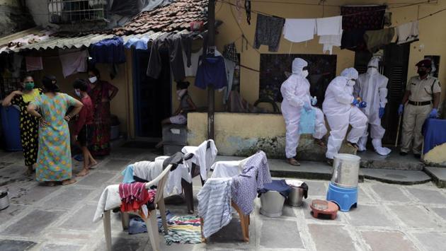 Health workers rest during a door-to-door screening of people for COVID-19 symptoms in Dharavi. The Dharavi slum is spread over 2.4 sqkm, has 850,000 residents and a population density of 354,167 per square kilometre, making it one of the most cramped spaces in Mumbai, itself the world’s fifth most densely populated city. (Rajanish Kakade / AP)