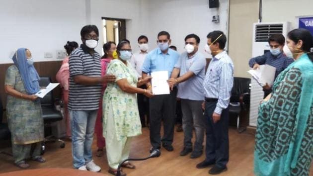 Members of Valmiki Samaj receive their domicile certificates in Jammu on Saturday.(HT Photo)