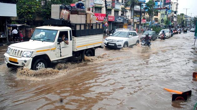 A motorist rides through a flooded street after heavy rain at Zoo Road in Guwahati on June 26. According to a report by PTI, the deluge has also overrun nearly 12,000 hectares of agricultural land with standing crops. (ANI)