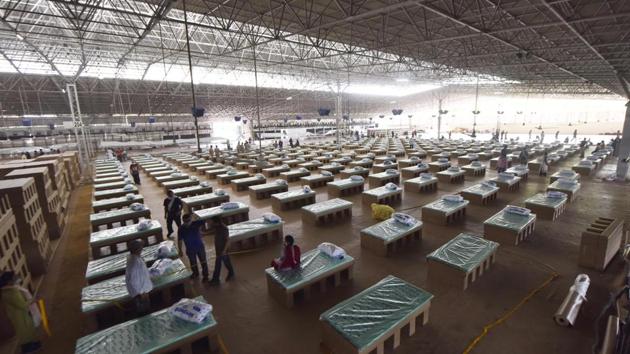 Volunteers seen setting up the Covid-19 care centre at Radha Soami Satsang Beas Bhati Mines facility in Chattarpur, New Delhi on June 26. Maharashtra, Delhi and Tamil Nadu have reported more than 60% of all cases in the country highlighting how the spread of the virus has been centred on a handful of hot spot areas. (Sanjeev Verma / HT Photo)