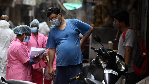 An ASHA worker conducts house-to-house Covid-19 screening at Karol Bagh, New Delhi on June 26. The screening exercise involves checking people for signs of flu such as fever, sore throat, cough and asking them about their travel history to map the virus. The aim is to identify people with Covid-like symptoms, create a comprehensive database and then get them tested. (Biplov Bhuyan / HT Photo)