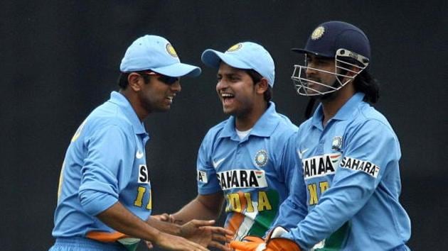 Indian cricket captain Rahul Dravid (L) is joined by Suresh Raina as they congratulate wicketkeeper Mahendra Dhoni(AFP via Getty Images)
