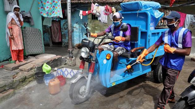 A municipal worker sprays disinfectant to sanitize a slum area to curb the spread of the coronavirus disease (COVID-19) in Kolkata on June 26. According to a report by HT, India has added 92,573 Covid-19 cases since June 20 and more than 3.18 lakhs since June 1. (Rupak De Chowdhuri / REUTERS)