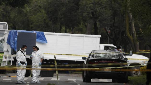 Forensic investigators and police work the scene where security secretary, Omar García Harfuch, was attacked by gunmen in the early morning hours in Mexico City. Heavily armed gunmen attacked and wounded Mexico City's police chief in a brazen operation that left an unspecified number of dead, Mayor Claudia Sheinbaum said Friday.(PTI)