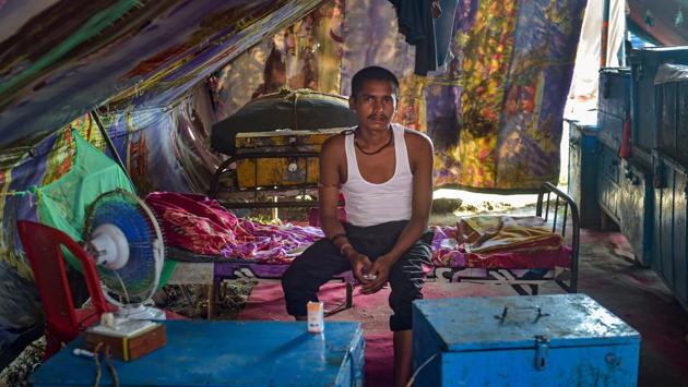 A circus troupe member seen inside his tent. The nationwide lockdown to curtail the spread of COVID-19 started on March 25, but the show had stopped even before that with fear of the disease keeping audiences away. (Mitesh Bhuvad / PTI)