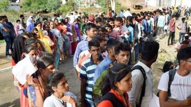 Applicants for Uttar Pradesh Police constable recruitment test wait in a queue outside their exam centre, in Prayagraj in June 2018. (PTI FILE PHOTO) Applicants for Uttar Pradesh Police constable recruitment test wait in a queue outside their exam centre, in Prayagraj in June 2018. (PTI FILE PHOTO)