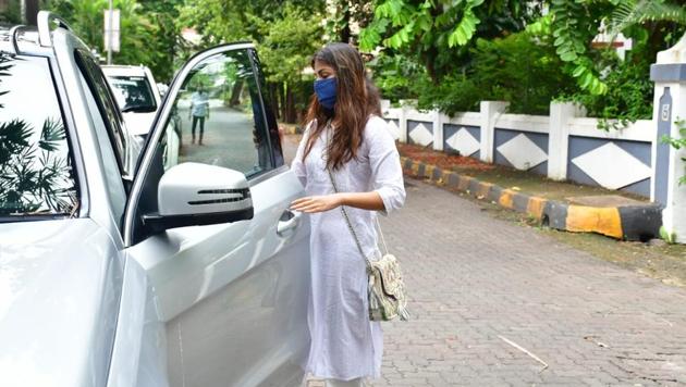 Rhea Chakraborty was dressed in a plain white salwar kameez, and wore a blue face mask. (Varinder Chawla)