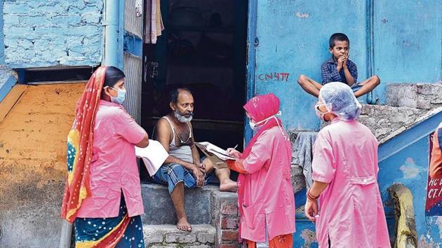 Asha workers speak to a resident during a door-to-door survey at JJ colony in Patparganj.(Raj K Raj/HT) Asha workers speak to a resident during a door-to-door survey at JJ colony in Patparganj.(Raj K Raj/HT)