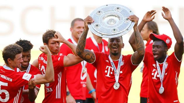 Bayern Munich's Jerome Boateng, Thomas Muller, Kingsley Coman, Leon Goretzka and Alphonso Davies celebrate with the trophy after winning the Bundesliga. (REUTERS)