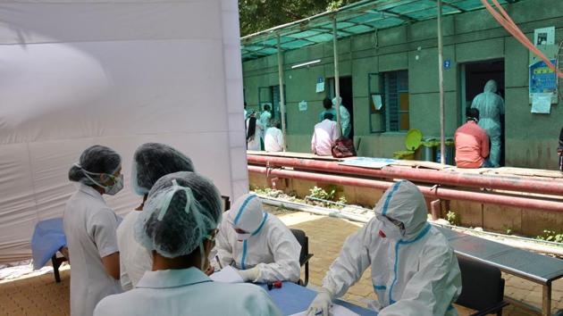 New Delhi: Doctors wearing protective suits sit outside the COVID 19 ward at Ram Manohar Lohia Hospital, during the nationwide lockdown in wake of the coronavirus pandemic, in New Delhi, Thursday, April 16, 2020. (PTI Photo)(PTI16-04-2020_000218A)(PTI) New Delhi: Doctors wearing protective suits sit outside the COVID 19 ward at Ram Manohar Lohia Hospital, during the nationwide lockdown in wake of the coronavirus pandemic, in New Delhi, Thursday, April 16, 2020. (PTI Photo)(PTI16-04-2020_000218A)(PTI)