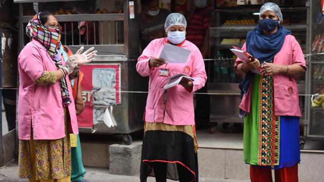 ASHA workers seen during a door-to-door survey for coronavirus in Pandav Nagar on June 26. The Delhi Asha Workers’ Association (DAWA) has given several representations to chief minister Arvind Kejriwal and health minister Satyendar Jain, requesting that the workers be paid Rs 10,000 per month during the pandemic. (Raj K Raj / HT Photo)