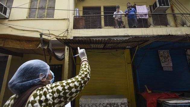 An Accredited Social Health Activist (ASHA) worker conducts a door-to-door survey for coronavirus in Karol Bagh's Ragarpura area, in New Delhi on June 26. Teams of ASHA workers and Auxiliary Nurse Midwife (ANMs) have been tirelessly mapping various parts of the city, screening its population to log the spread of Covid-19 as part of a survey ordered by the Centre last week. (Biplov Bhuyan / HT Photo)