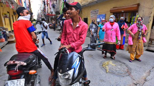 ASHA workers admonish boys out without face masks during a door to door screening survey in Pandav Nagar on June 26. Kavita Yadav, the state coordinator for ASHA workers, All India United Traders Union Centre (AIUTUC), said they have a list of 100-plus Asha workers who tested positive for Covid-19. The first Asha worker tested positive for Covid-19 in April. (Raj K Raj / HT Photo)
