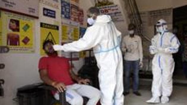 Health workers collect a sample to test for Covid-19, Gurugram, June 27, 2020(Parveen Kumar/HTPhoto)