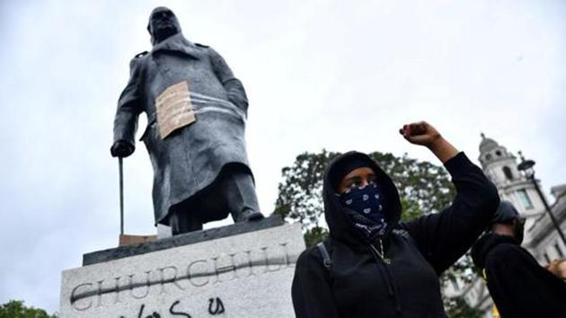 File photo of a demonstrator reacts in front of graffiti on a statue of Winston Churchill in Parliament Square , Lonon, during a Black Lives Matter protest in London, following the death of George Floyd who died in police custody in US.(Reuters File Photo)