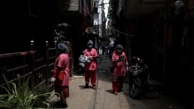 “I’m the only earning member in my family, as my husband lost his job in February. As part of Covid-19 duty, we have to cover 50 or more houses daily for the survey. We are on duty all the time. Sometimes I get a call at night to locate a Covid-19 positive patient. After putting in long hours, all we get is Rs 4,000, including Rs 1,000 for Covid-19 duty,” Rajan Bidhuri, who is deployed in Tughlaqabad village told HT. (Anushree Fadnavis / REUTERS)